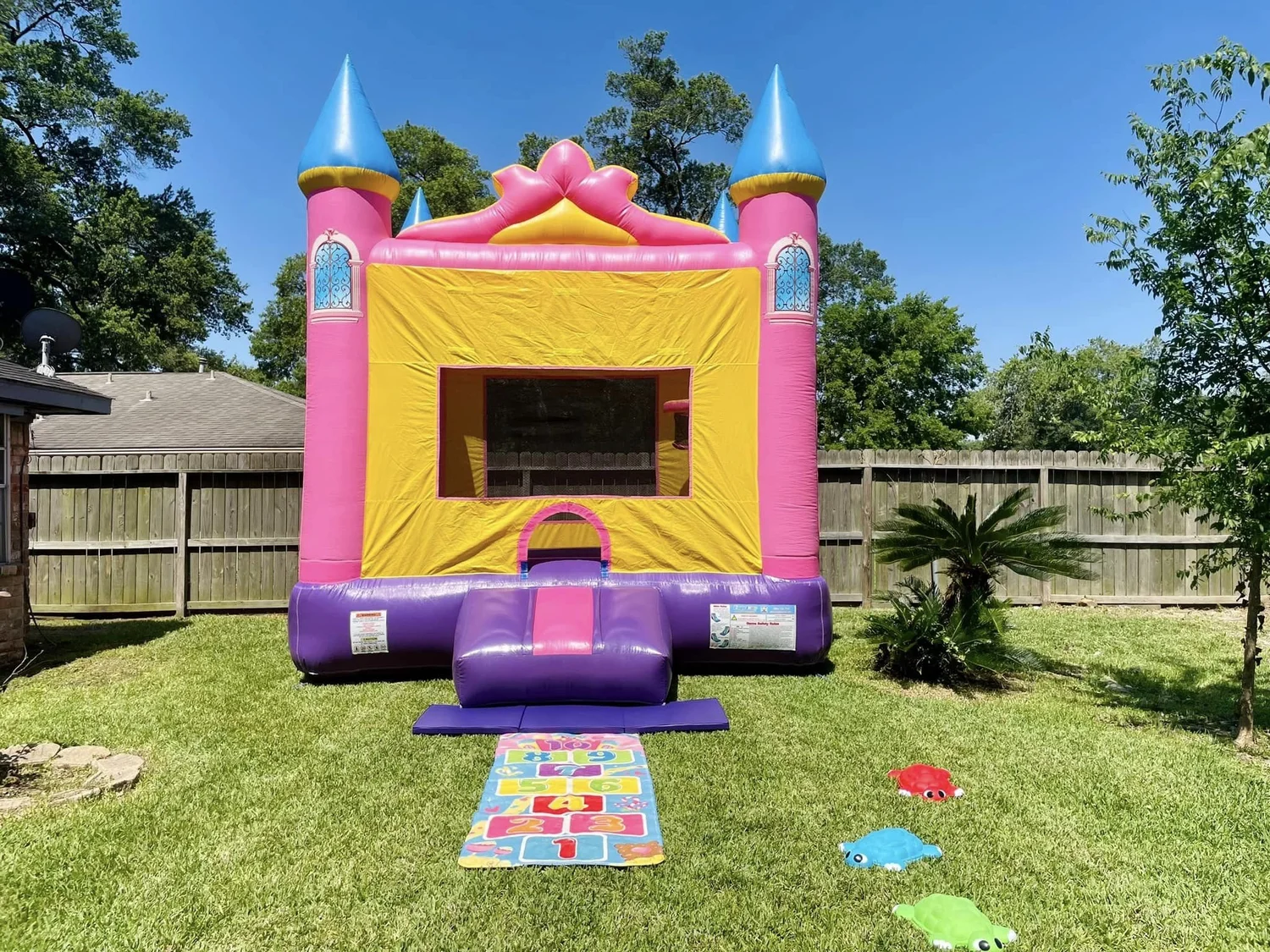Princess bounce house set up in a backyard