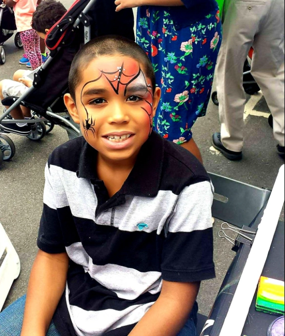 Spider-Man face painting at a festival